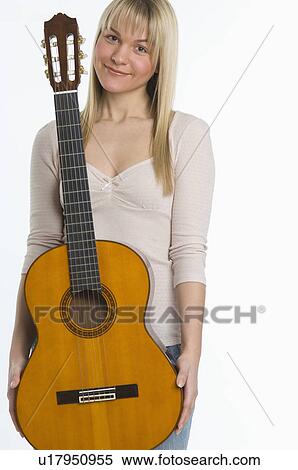Stock Photography - Studio shot of woman with guitar. Fotosearch