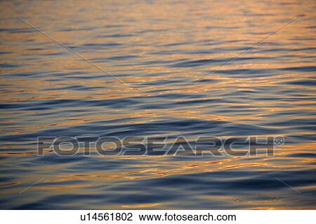 Stock Image - Subtle sunshine on water. Fotosearch