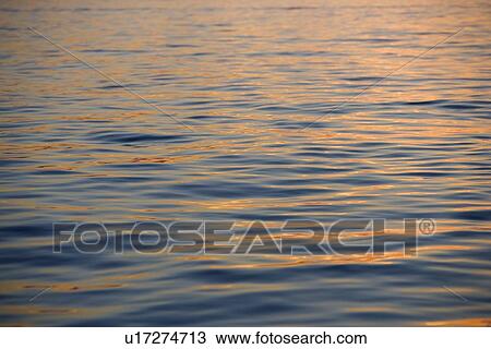 Stock Image - Subtle sunshine on water. Fotosearch