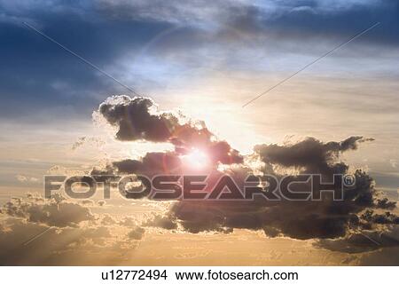 Picture - Sunset through clouds. Fotosearch