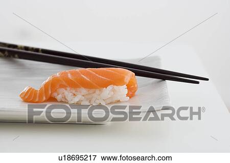 Sushi with chopsticks View Large Photo Image Stock Photo - Sushi with chopsticks. Fotosearch