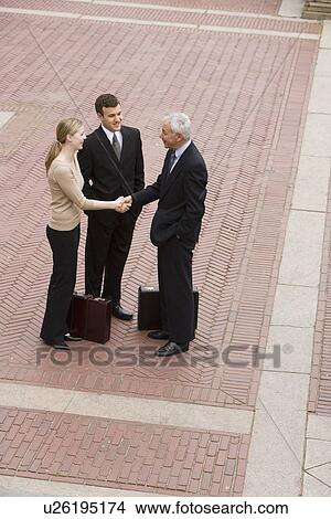 Three business people meeting outdoors View Large Photo Image Picture - Three business people meeting outdoors. Fotosearch