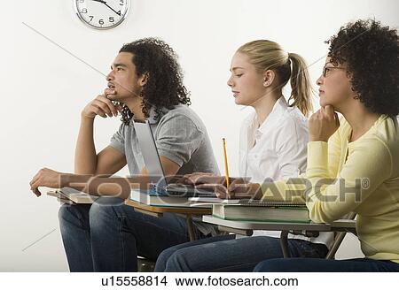 Three college students in class View Large Photo Image Picture - Three college students in class. Fotosearch