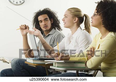 Three college students in class View Large Photo Image Picture - Three college students in class. Fotosearch