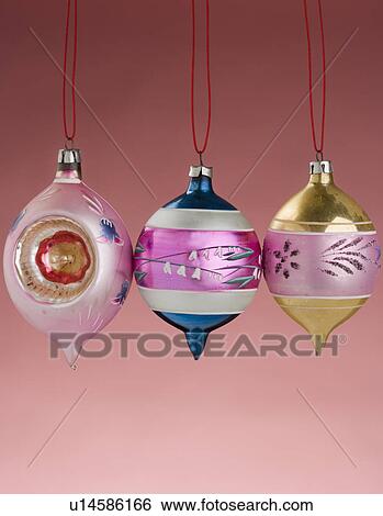 Stock Photograph - Three hanging Christmas ornanaments. Fotosearch