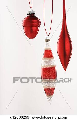 Stock Photography - Three hanging Christmas ornanaments. Fotosearch