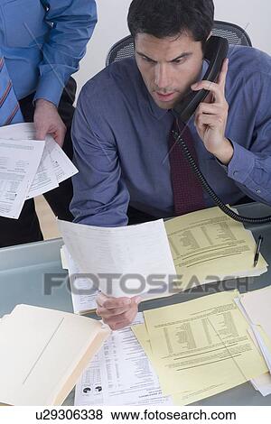Two business men at work View Large Photo Image Stock Photo - Two business men at work. Fotosearch