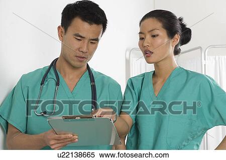 Two doctors conferring View Large Photo Image Stock Photography - Two doctors conferring. Fotosearch