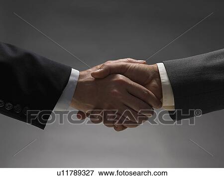 Stock Photo - Two men shaking hands. Fotosearch