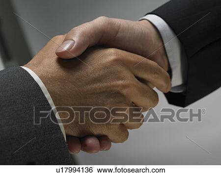 Stock Photograph - Two men shaking hands. Fotosearch