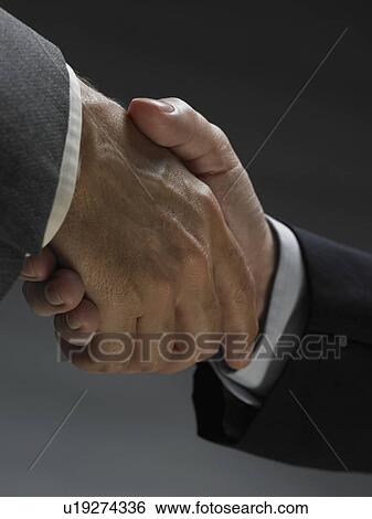 Stock Photograph - Two men shaking hands. Fotosearch