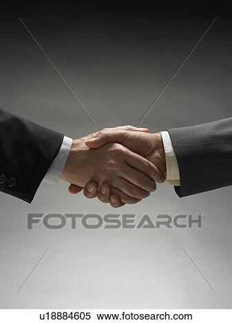 Stock Photography - Two men shaking hands. Fotosearch