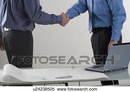 Stock Photography - Two men shaking hands. Fotosearch