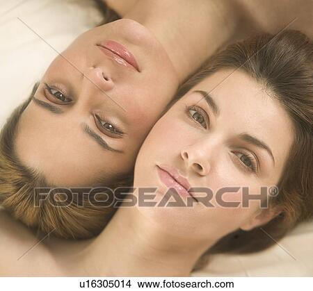 Two women lying cheek to cheek View Large Photo Image Picture - Two women lying cheek to cheek. Fotosearch