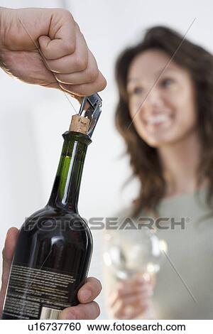 Stock Image - Uncorking bottle of wine. Fotosearch