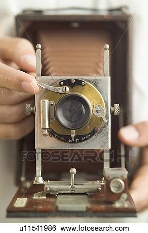 Stock Photograph - Using an antique folding camera. Fotosearch