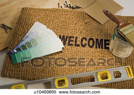 Stock Photography - Welcome mat with paint and tools. Fotosearch