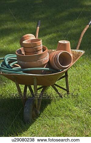 Wheelbarrow and gardening tools View Large Photo Image Stock Photo - Wheelbarrow and gardening tools. Fotosearch