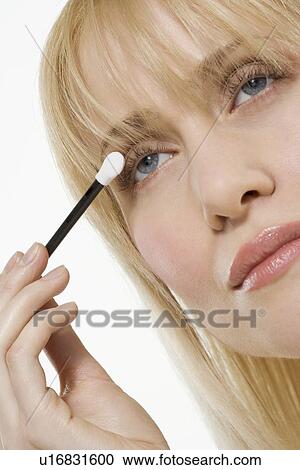 Woman applying eye shadow View Large Photo Image Stock Image - Woman applying eye shadow. Fotosearch