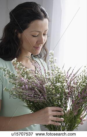 Stock Photo - Woman arranging a bouquet of flowers. Fotosearch