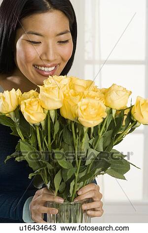 Woman arranging flowers in vase View Large Photo Image Stock Image - Woman arranging flowers in vase. Fotosearch