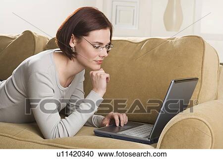 Woman at home using computer View Large Photo Image Stock Image - Woman at home using computer. Fotosearch