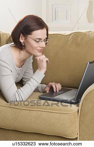 Woman at home using computer View Large Photo Image Stock Image - Woman at home using computer. Fotosearch