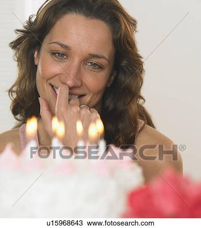 Stock Image - Woman celebrating her birthday. Fotosearch
