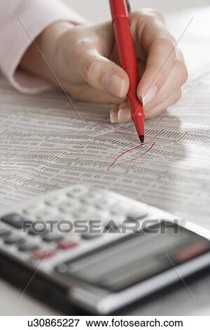 Woman checking financial page with calculator View Large Photo Image Stock Photo - Woman checking financial page with calculator. Fotosearch