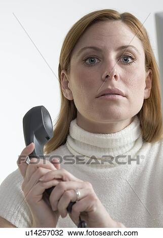 Woman covering mouthpiece of phone View Large Photo Image Stock Image - Woman covering mouthpiece of phone. Fotosearch