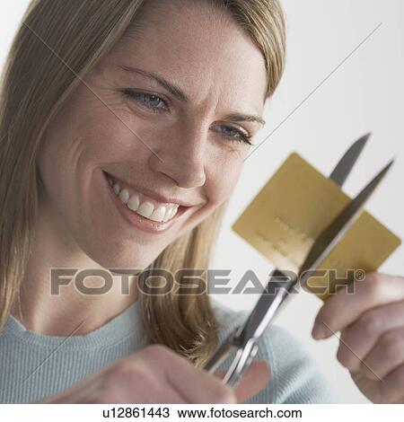 Woman cutting up credit card View Large Photo Image Stock Image - Woman cutting up credit card. Fotosearch