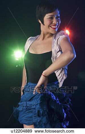 Woman dancing at nightclub View Large Photo Image Stock Photo - Woman dancing at nightclub. Fotosearch
