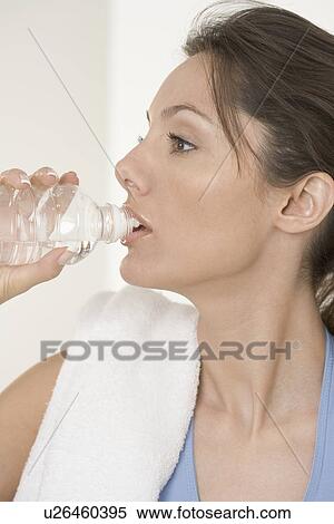 Woman drinking from water bottle View Large Photo Image Stock Photography - Woman drinking from water bottle. Fotosearch