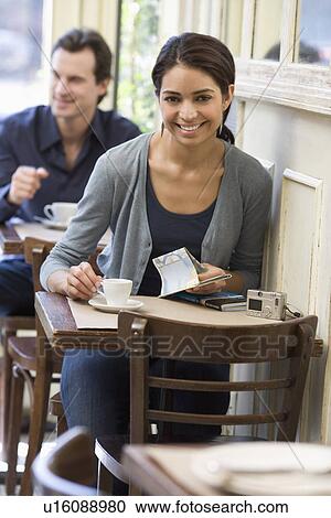 Woman having coffee at restaurant View Large Photo Image Stock Image - Woman having coffee at restaurant. Fotosearch