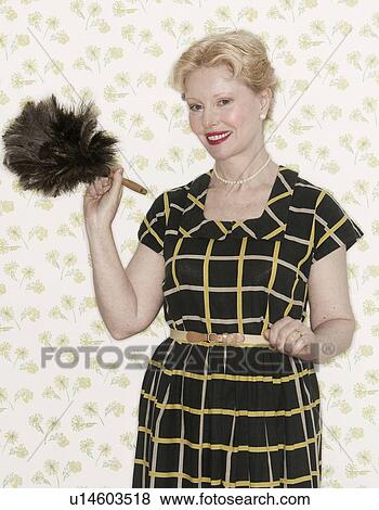 Stock Photo - Woman holding a feather duster. Fotosearch