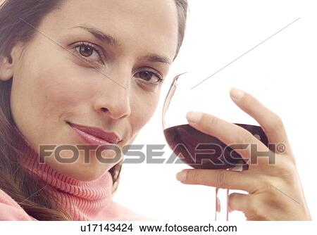 Woman holding a glass of red wine View Large Photo Image Picture - Woman holding a glass of red wine. Fotosearch