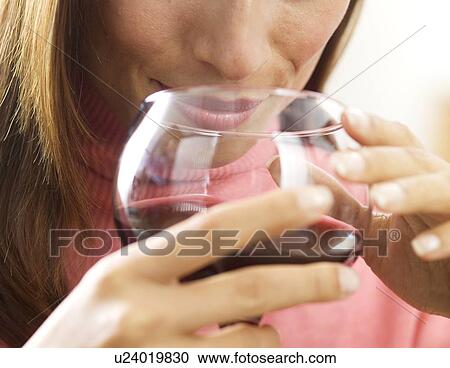 Stock Image - Woman holding a glass of wine. Fotosearch