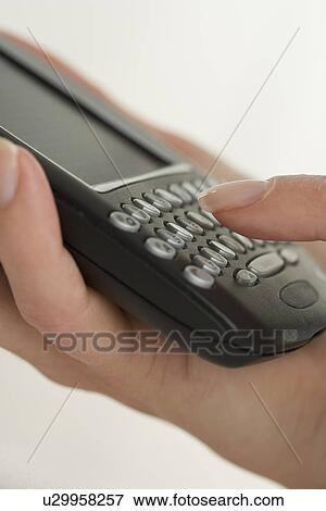 Stock Photo - Woman holding a smart phone. Fotosearch