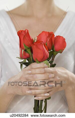 Picture - Woman holding bouquet of roses. Fotosearch