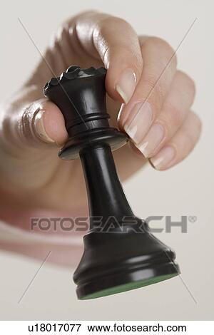 Woman holding chess piece View Large Photo Image Stock Photo - Woman holding chess piece. Fotosearch