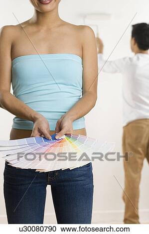Stock Image - Woman holding color samples. Fotosearch