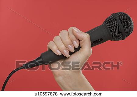 Stock Photo - Woman holding microphone. Fotosearch