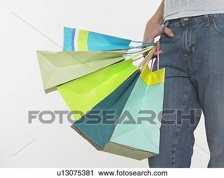 Woman holding shopping bags View Large Photo Image Stock Image - Woman holding shopping bags. Fotosearch