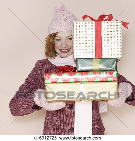 Woman holding stack of presents View Large Photo Image Stock Photography - Woman holding stack of presents. Fotosearch