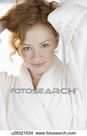 Woman in bathrobe holding hair up View Large Photo Image Picture - Woman in bathrobe holding hair up. Fotosearch