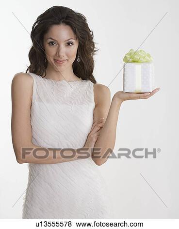 Woman in formal dress holding gift View Large Photo Image Stock Photo - Woman in formal dress holding gift. Fotosearch