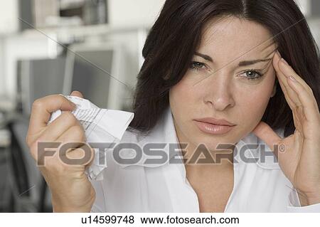 Stock Photo - Woman in office having a bad day. Fotosearch