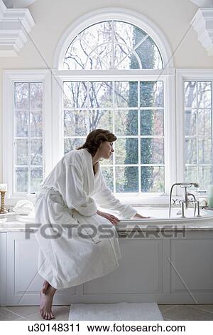 Woman in robe drawing bath View Large Photo Image Stock Image - Woman in robe drawing bath. Fotosearch