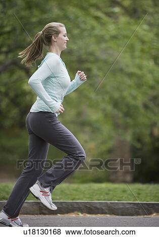 Stock Photo - Woman jogging in park. Fotosearch