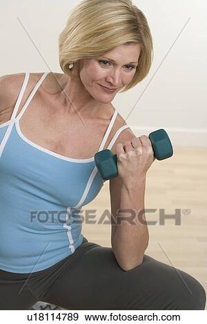 Woman lifting weights View Large Photo Image Stock Photo - Woman lifting weights. Fotosearch